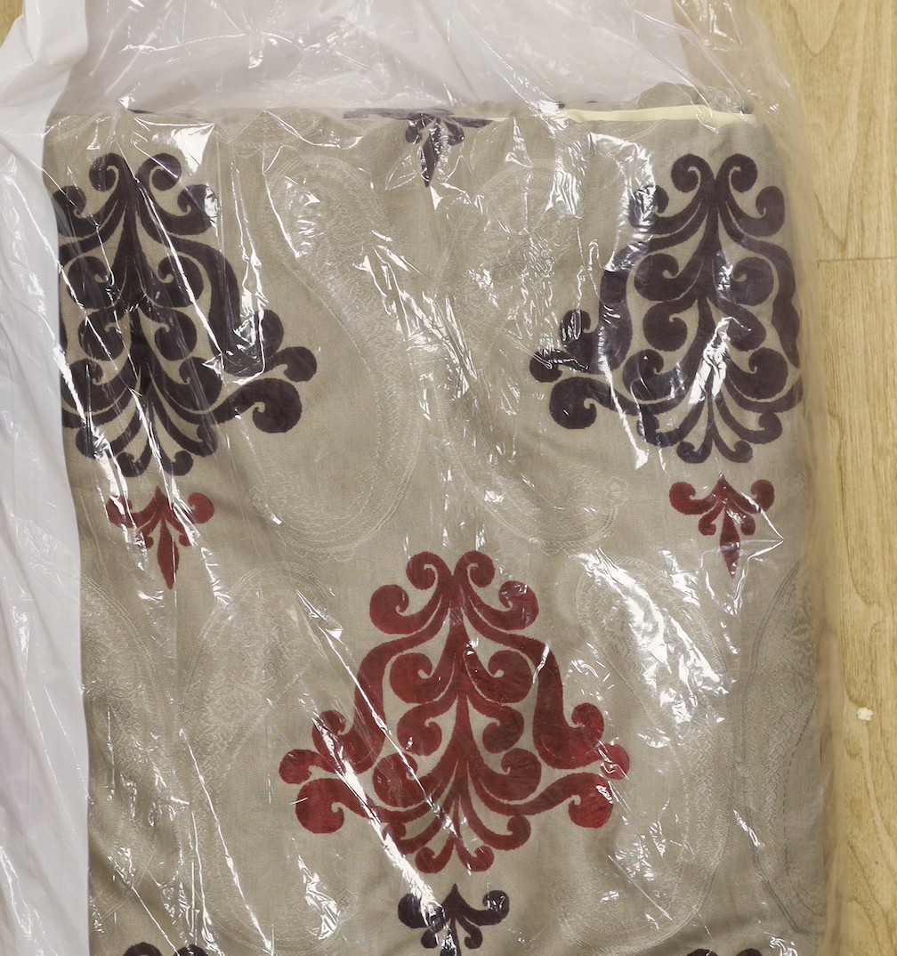 A large pair of silver brocaded curtains, with a woven paisley tear drop motif and large all over plum cut velvet Fleur-de-lis motifs, together with matching corded and tasselled tie backs.
